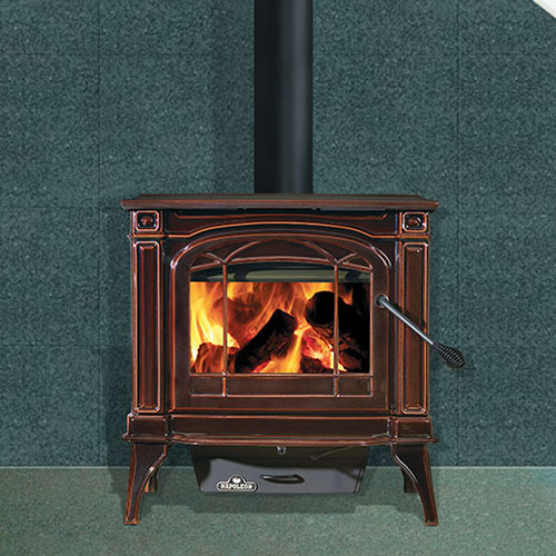 Napoleon Banff Wood Stove in bronze with large flames and stove pipe.