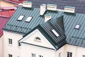 wet, dark green roof with chimney