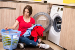 confused woman doing laundry