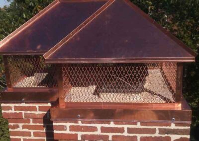 Double copper chimney caps.