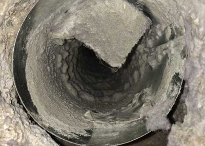 Dryer vent loaded with lint inside pipe.