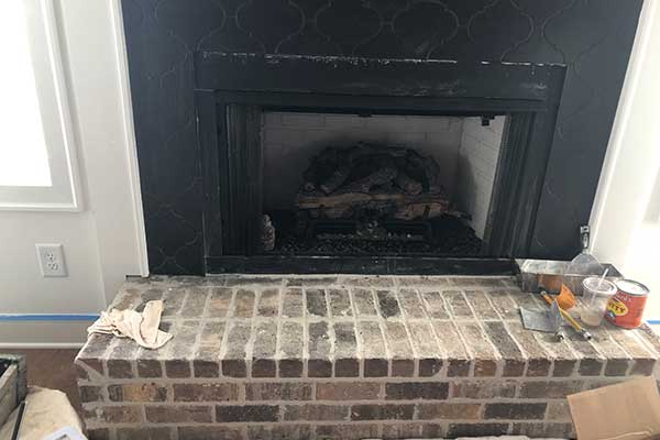 New Fireplace Construction - Sweeps and Ladders New fireplace construction with mortar joint equipment sitting on a stone hearth.