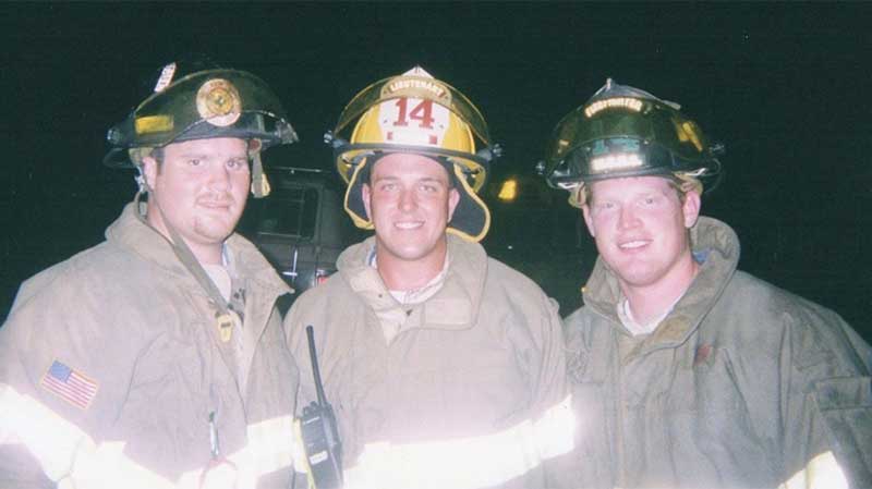 Tommy and two other firefighters dressed in full gear.
