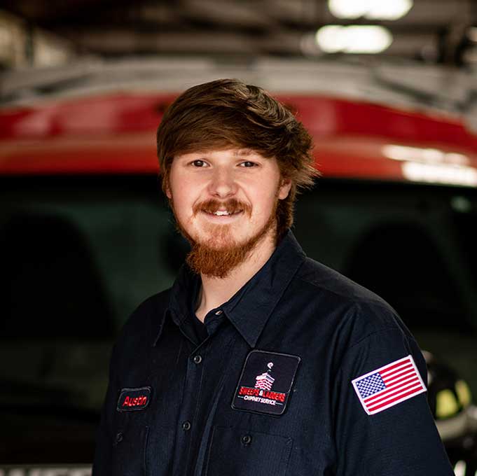 Original photo of Austin Criswell - Sweeps and Ladders Austin Criswell apprentice auburn hair beard wearing a logo shirt.
